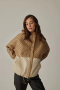 Women's short hooded quilted jacket in beige.