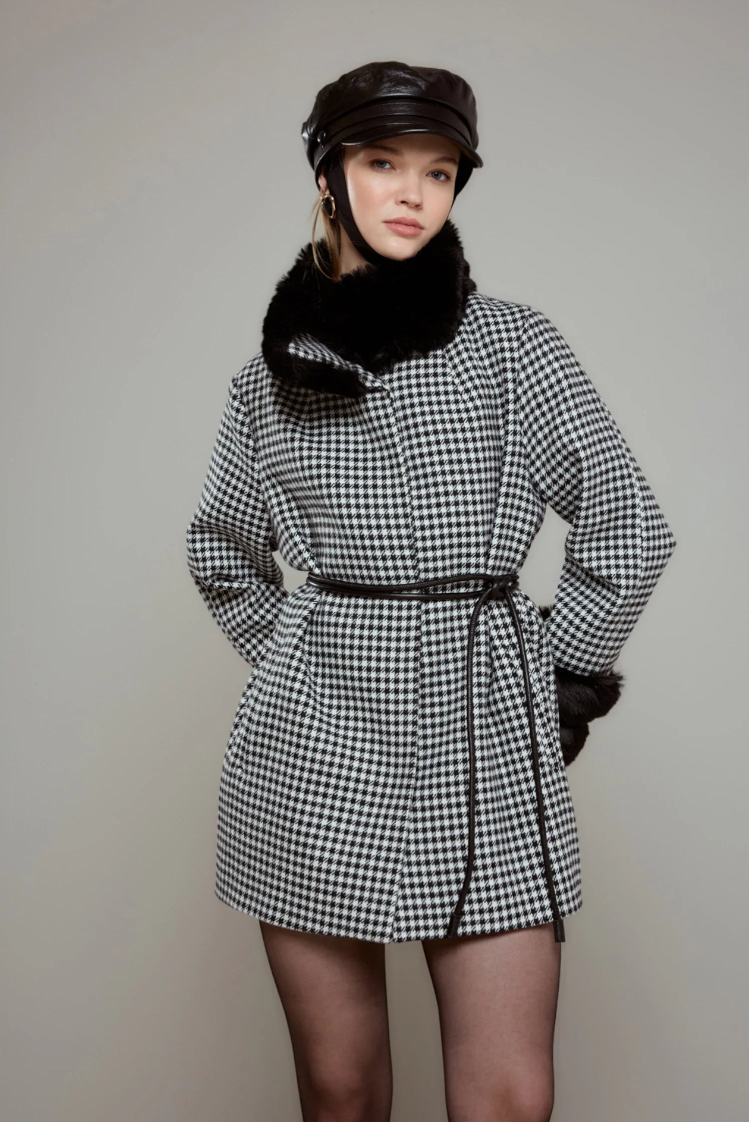 Women's coat with houndstooth pattern and plush details.