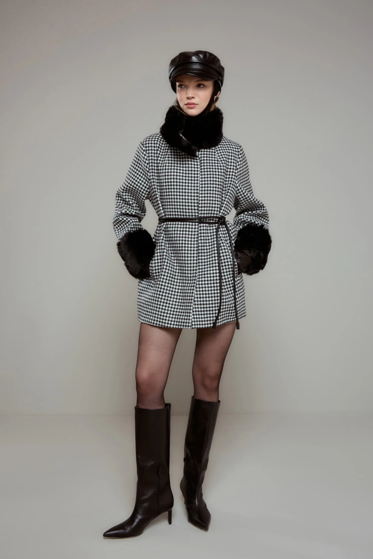Women's coat with houndstooth pattern and plush details.